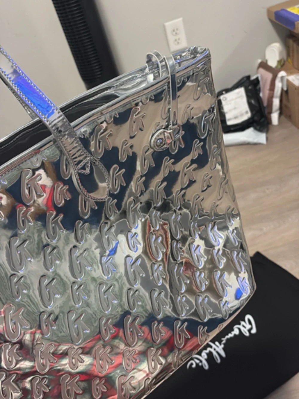 Shimmering Silver Tote with Embossed Monogram Pattern